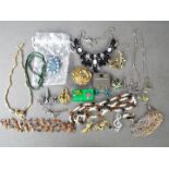 Twelve brooches with various designs including stone set animals, musical instruments and similar,