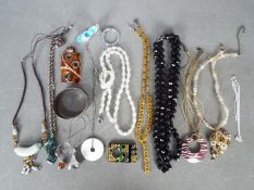 A hallmarked silver cuff bracelet, Birmingham assay, four silver necklaces with various pendants,