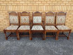 Four upholstered dining chairs and one carver.