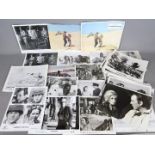 A collection of film studio promotional motion picture stills, predominantly black and white.