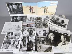 A collection of film studio promotional motion picture stills, predominantly black and white.