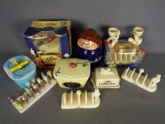 A collection of promotional ceramics to include Lurpak toast racks, butter dishes, egg cups,