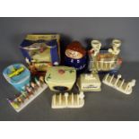 A collection of promotional ceramics to include Lurpak toast racks, butter dishes, egg cups,