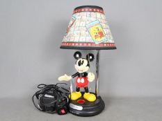 A Disney, Mickey Mouse 'Through The Ages' table lamp, approximately 47 cm (h).