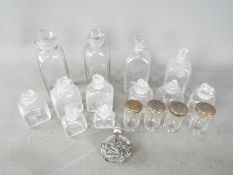 A collection of vintage glass bottles and stoppers,