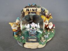 A Disney musical snow globe featuring the Seven Dwarfs from the film 'Snow White And The Seven