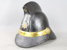 A vintage leather and brass fireman's helmet, with liner and badge for Bootle Fire Brigade.