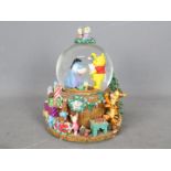 A Disney musical snow globe, Winnie The Pooh, approximately 21 cm (h).