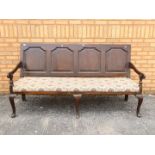 A good quality settle with upholstered seat, approximately 99 cm x 182 cm x 72 cm.