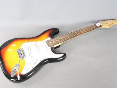 A Pitchmaster electric guitar in sunburst finish.