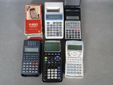 A small collection of vintage calculators to include Casio, Texas Instruments and Sharp.