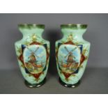 A large pair of continental glass vases decorated with a coastal village scene with windmill and a