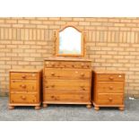 A pine vanity chest of drawers 132 cm x 76 cm x 46 cm and two bedside chests 57 cm x 45 cm x 46 cm.