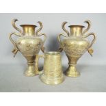 A pair of Indian twin handled vases with intricate, chased decoration,