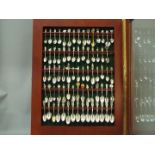 A display case housing a quantity of souvenir collector spoons,