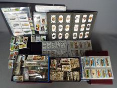 A large quantity of cigarette and tea cards, loose examples and contained in albums.