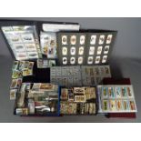 A large quantity of cigarette and tea cards, loose examples and contained in albums.
