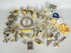 A collection of brass ornaments, a Vogue Vanities powder compact, silver plated trowel and similar.