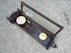 A good quality contemporary dark wood cased wall timepiece,