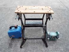 A Black & Decker Workmate, a bench grinder and an air compressor.