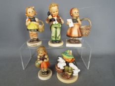 Hummel - Five Hummel figurines comprising a boy with a telephone, girls with baskets and similar,