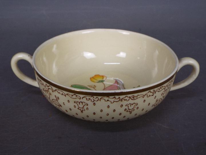 A Clarice Cliff twin handled bowl for A J Wilkinson Ltd, floral decoration and gilt rim,
