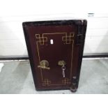 A small vintage safe measuring approximately 51 cm x 33 cm x 36 cm, with key.