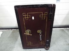 A small vintage safe measuring approximately 51 cm x 33 cm x 36 cm, with key.