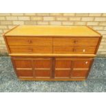 A Nathan sideboard having four drawers over a twin door cupboard,