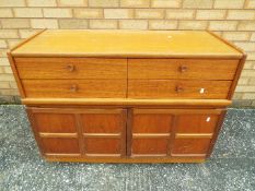 A Nathan sideboard having four drawers over a twin door cupboard,