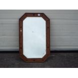A wood framed, bevelled edge mirror, approximately 52 cm x 82 cm.