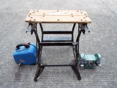 A Black & Decker Workmate, a bench grinder and an air compressor.