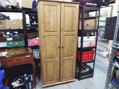 A twin door wardrobe measuring approximately 188 cm x 86 cm x 54 cm.
