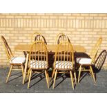 An Ercol dining table and six chairs, approximately 72 cm 153 cm x 75 cm.