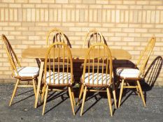 An Ercol dining table and six chairs, approximately 72 cm 153 cm x 75 cm.