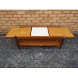 An extending coffee table, approximately 43 cm x 104 (146) cm x 42 cm.