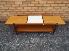 An extending coffee table, approximately 43 cm x 104 (146) cm x 42 cm.