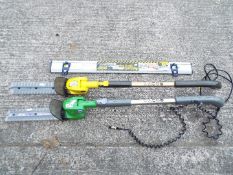 Two Gtech cordless hedge trimmers and a spirit level.