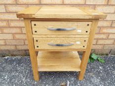 A light oak lamp table measuring approximately 60 cm x 50 cm x 35 cm.