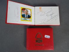 Two Nottingham Forest brand autograph books containing a quantity of football related autographs