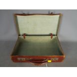 A small vintage briefcase or attache cas