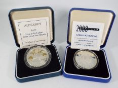Two silver proof coins comprising Alderney 1999 Total Solar Eclipse £5 and 2000 Millennium £5,