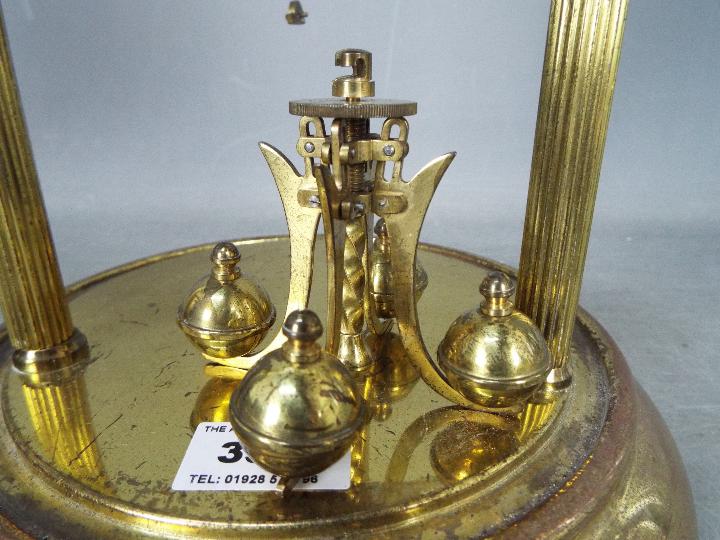 An early 20th century 400-day torsion clock, large 11cm enamel dial, mounted between reeded pillars, - Image 3 of 7