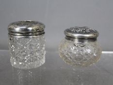 Two silver topped dressing table jars, one of Chester assay 1918, the other Birmingham assay 1922,