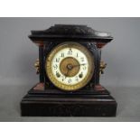 A late 19th century Ansonia Clock Company, black painted, cast iron mantel clock,
