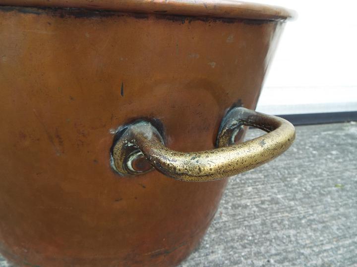 A large copper and brass preserving pan with twin handles, approximately 33 cm (h) x 47 cm (d). - Image 2 of 4