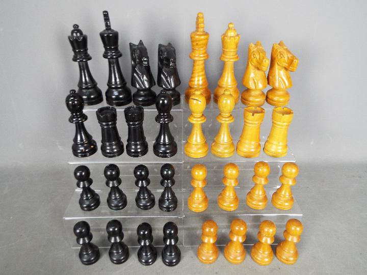 A carved wooden chess set with 16 cm king.