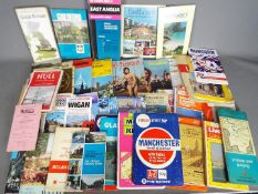A collection of vintage maps, tourist guides and similar.