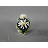 Moorcroft - a small trial vase by Moorcroft in the Daisy design,