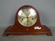 A vintage Napoleons hat mantel clock with key and pendulum.